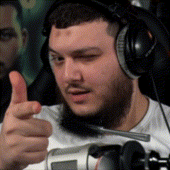 a man with a beard and headphones is giving a thumbs up .