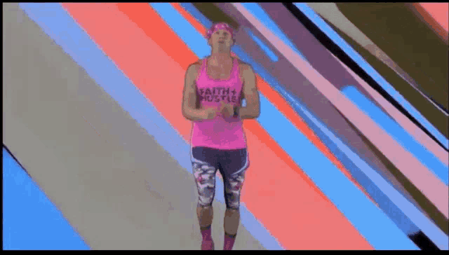 a man in a pink tank top and shorts is running