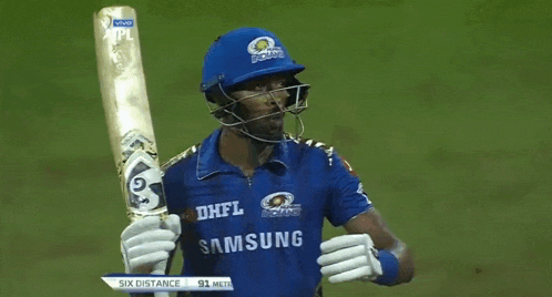a cricket player wearing a blue shirt that says samsung is holding a bat .