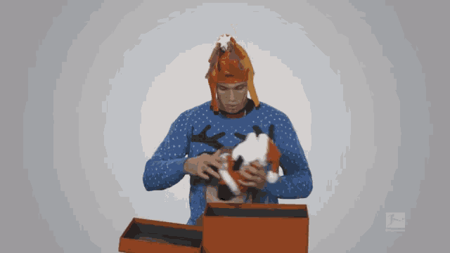 a man wearing an ugly christmas sweater is holding a stuffed santa claus