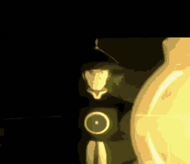 a close up of a light bulb with a green light behind it