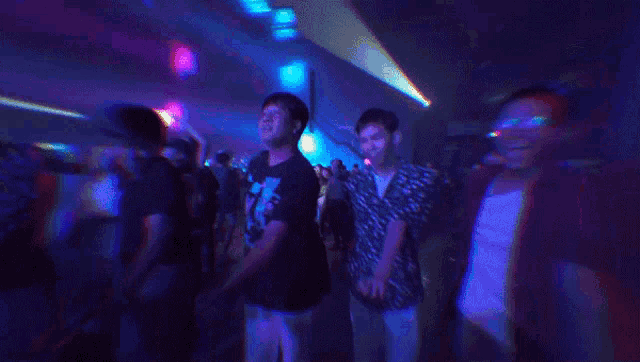 a blurry picture of a crowd of people dancing in a club