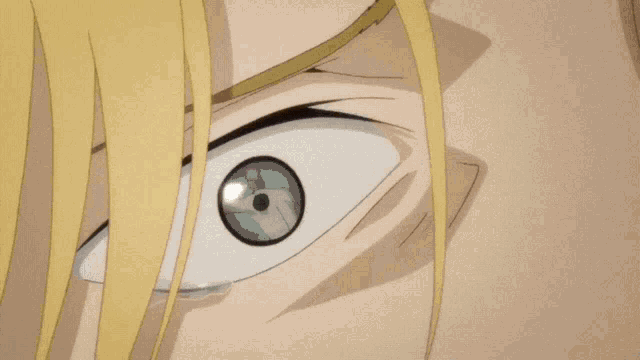 a close up of a man 's face with yellow hair and blue eyes