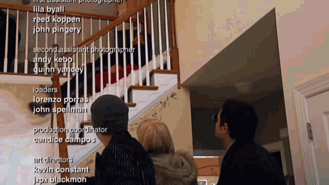 a group of people are standing in front of a staircase with the names of their contributors