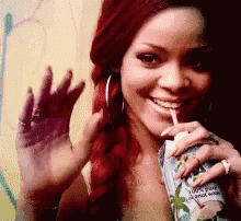 a woman with red hair drinking from a can that says 100 % pure almond water
