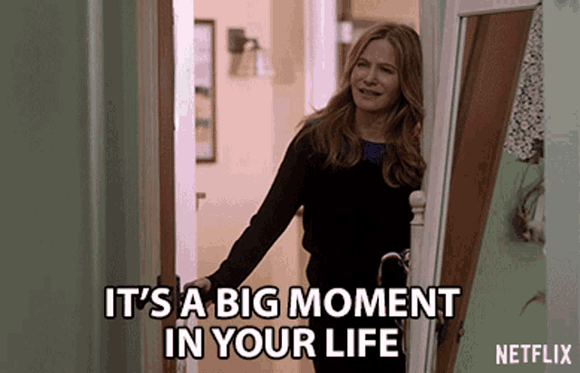 a woman is standing in a doorway with the words it 's a big moment in your life