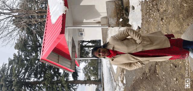 a woman is standing in front of a red roof