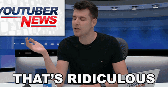 a man is sitting in front of a youtuber news sign