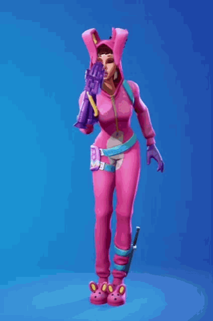 a girl in a pink bunny outfit is holding a heart and an arrow