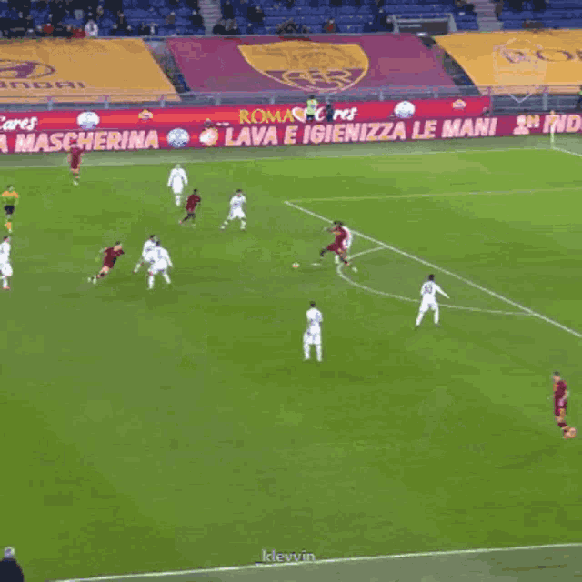 a soccer field with a banner that says lava e igienizza le mani on it