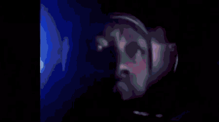 a blurry picture of a person 's face with a glowing light behind them