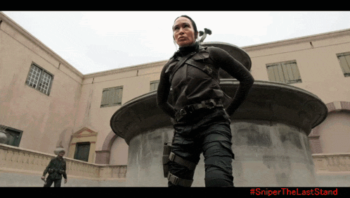 a poster for sniper the last stand shows a woman in black standing in front of a building
