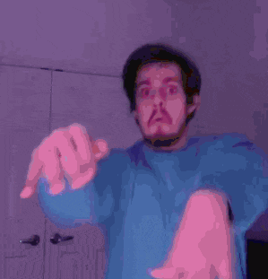 a man with a beard is praying with his hands together