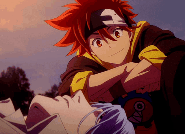 a boy with red hair is hugging another boy who is laying on the ground