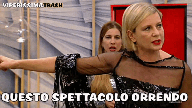 a woman in a black sequined dress says " questo spettacolo orrendo " in a foreign language
