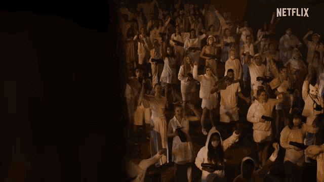 a large group of people are dancing in front of a netflix sign