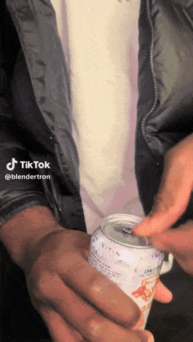 a person is opening a can with a tiktok watermark on the bottom