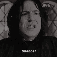 a black and white photo of a man making a funny face and saying silence .