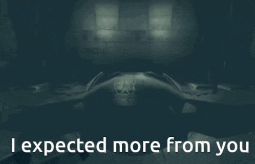a man in a black leather jacket is standing in front of a sign that says i expected more from you