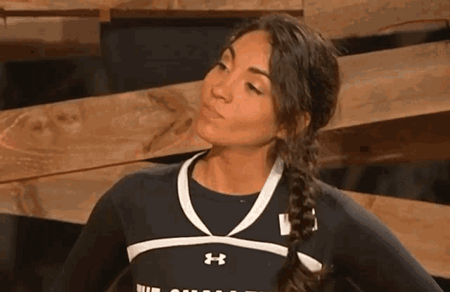 a woman wearing a black and white under armour shirt