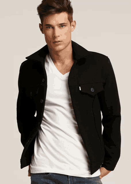 a man wearing a black jacket and a white t-shirt
