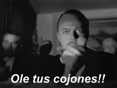 a man with a mustache is clapping in a black and white photo with the words ole tus cojones !