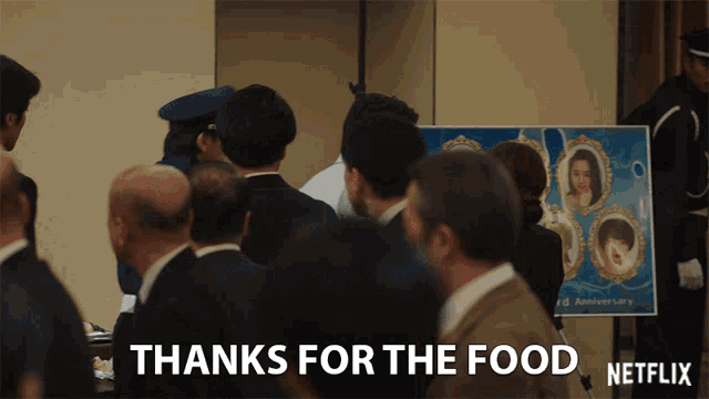 a group of people are gathered in front of a sign that says thanks for the food netflix