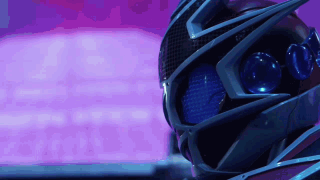 a close up of a helmet with blue eyes