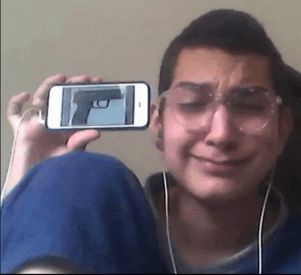 a man is taking a picture of himself with a gun on his phone