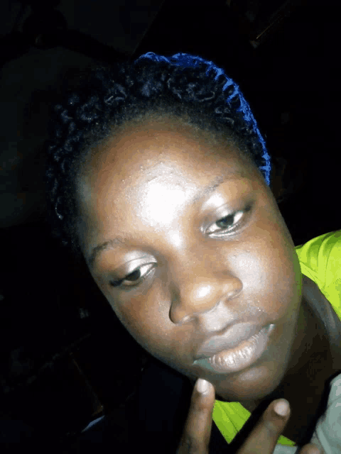 a close up of a woman 's face with a blue headband