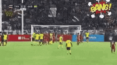 a group of soccer players are playing on a field with a sign that says bang
