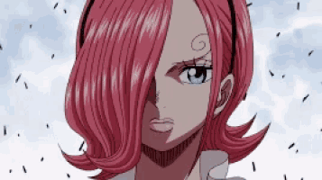 a close up of a woman with pink hair and blue eyes .
