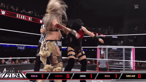 wrestlers in a ring with a scoreboard that says deadline