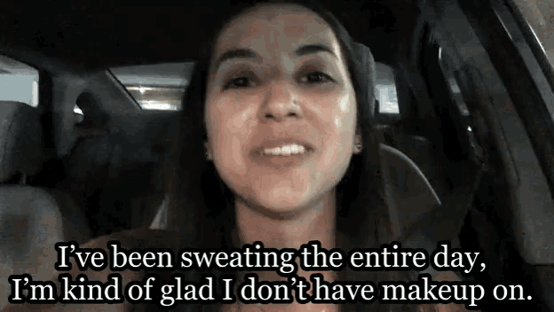 a woman is sweating the entire day while sitting in the back seat of a car .