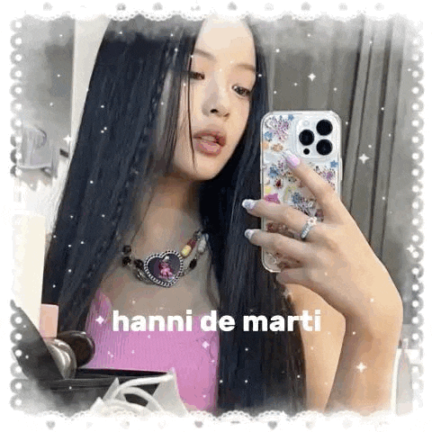 a woman is taking a selfie in front of a mirror with her phone .