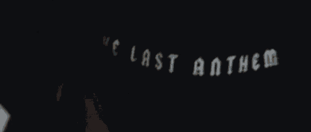 a group of people are standing in a dark room in a dark room .