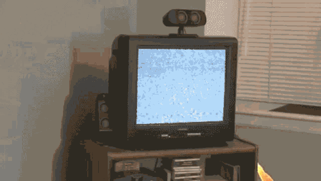 a samsung television is sitting on a wooden stand