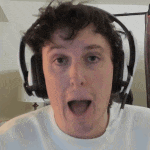 a man is wearing headphones and making a funny face .