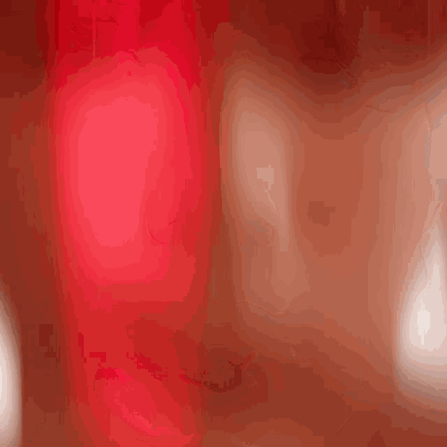 a close up of a woman 's face with a red light shining on it .