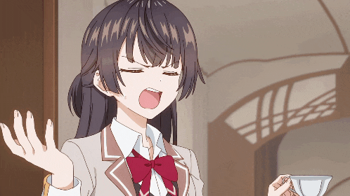 a girl in a school uniform is making a funny face and holding a cup