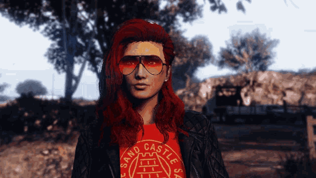 a woman with red hair wearing sunglasses and a red shirt that says sand castles