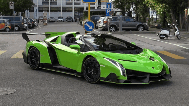 a green car is parked in a parking lot