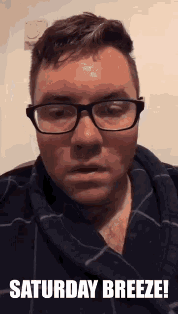 a man wearing glasses says saturday breeze on the bottom