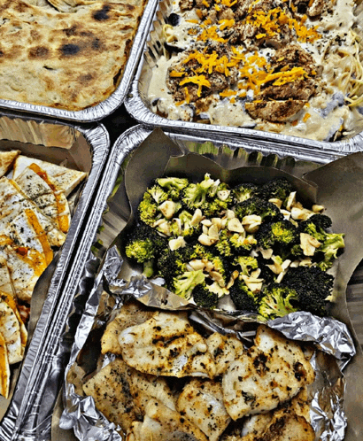 aluminum foil containers filled with chicken broccoli and cheese