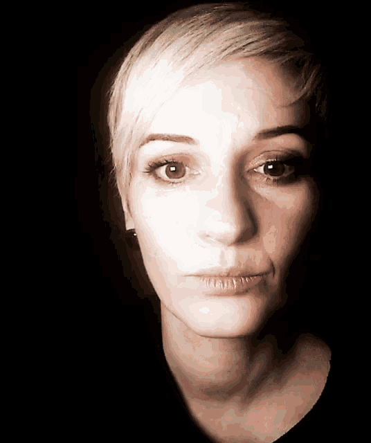 a close up of a woman 's face with a serious look on her face