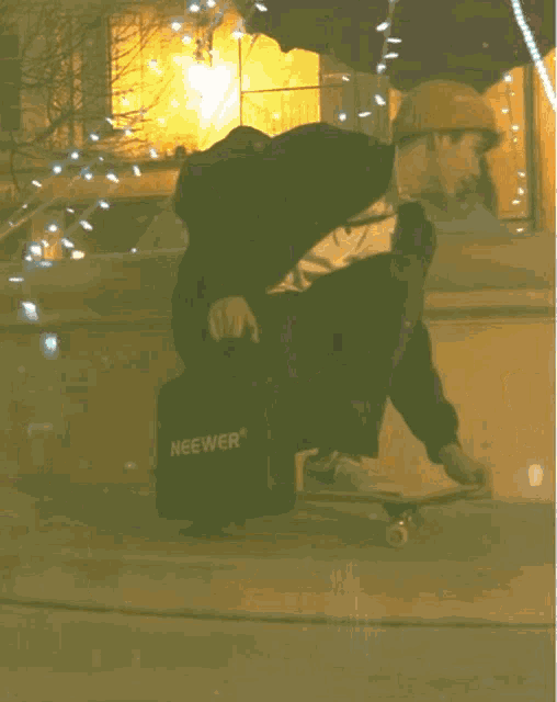 a person riding a skateboard with a bag that says neewer on the back