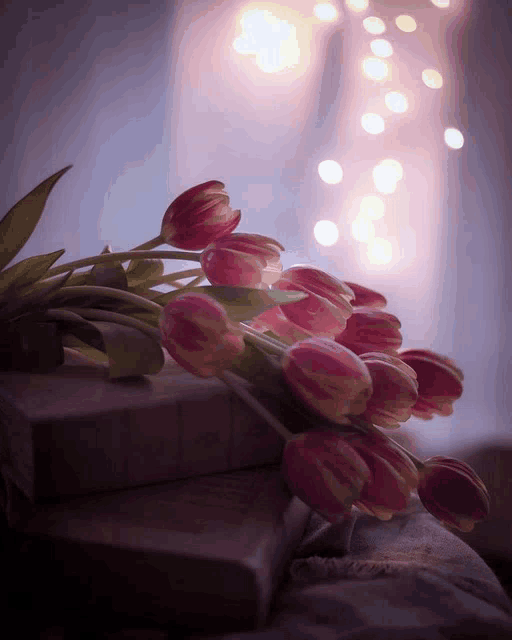 a bunch of pink flowers on top of a book