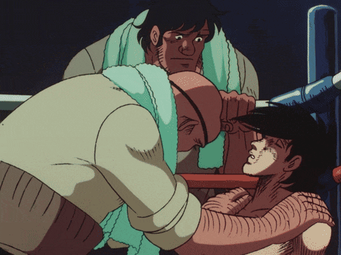 a man with a towel around his neck looks at another man