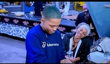 a man and a woman are standing next to each other in a room .