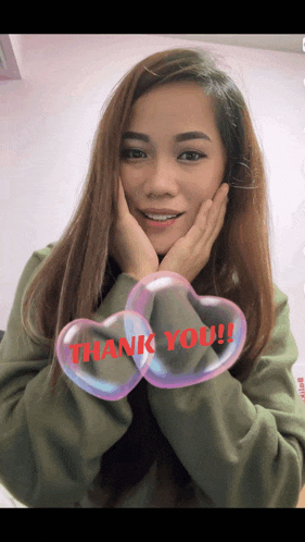 a woman with her hands on her face and the words thank you on her sleeve
